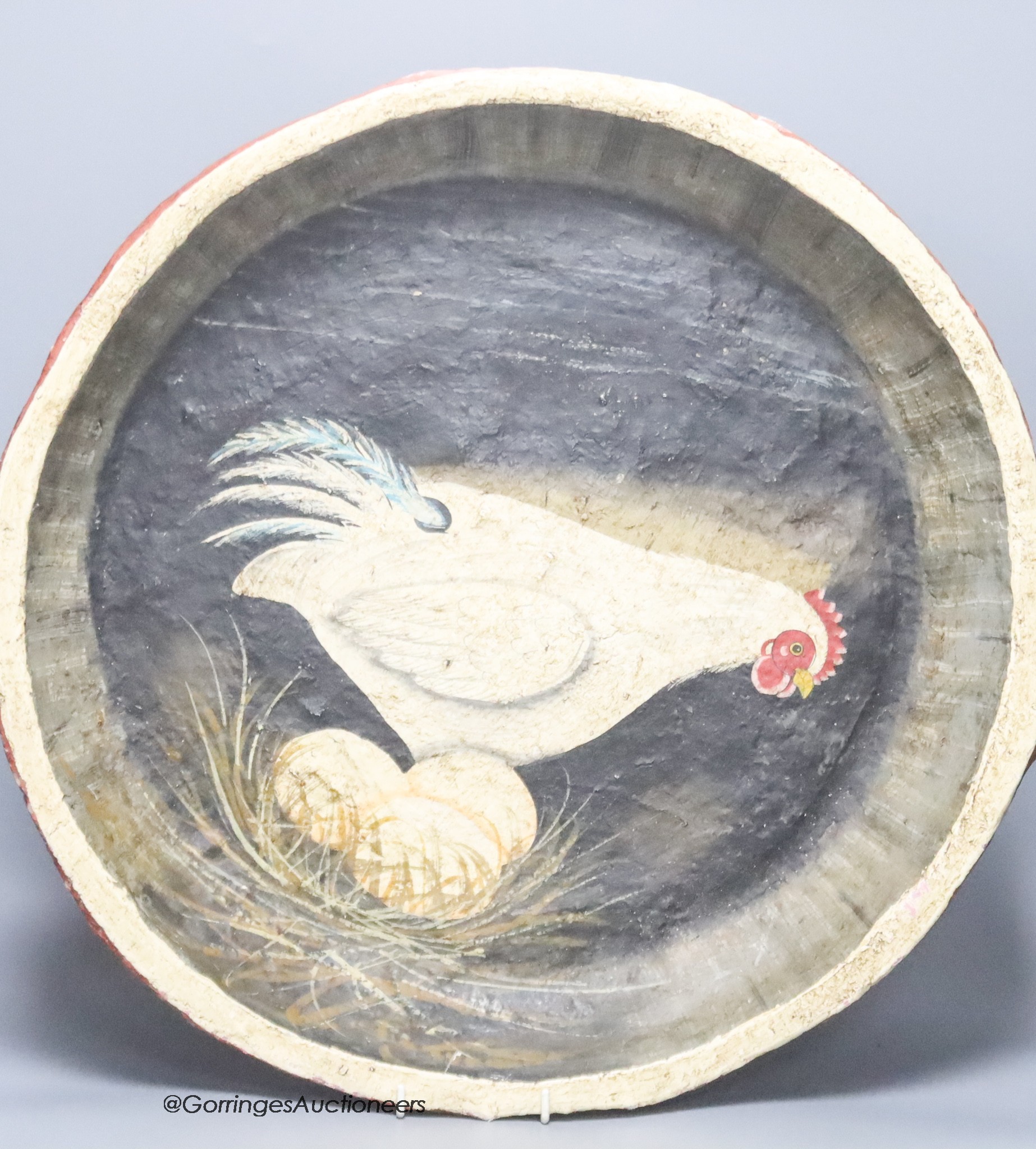 A papier mache dish with a painted interior of a chicken and eggs, diameter 52cm